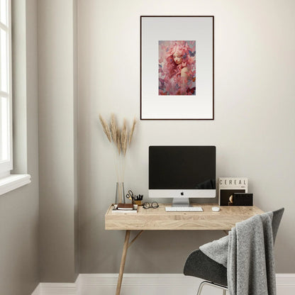 Minimalist home office with wooden desk, computer, and Winds Arise framed wall art