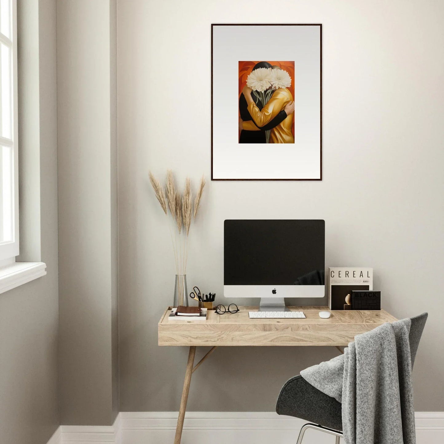 Minimalist home office with wooden desk, computer, and Embrace Aether framed wall art