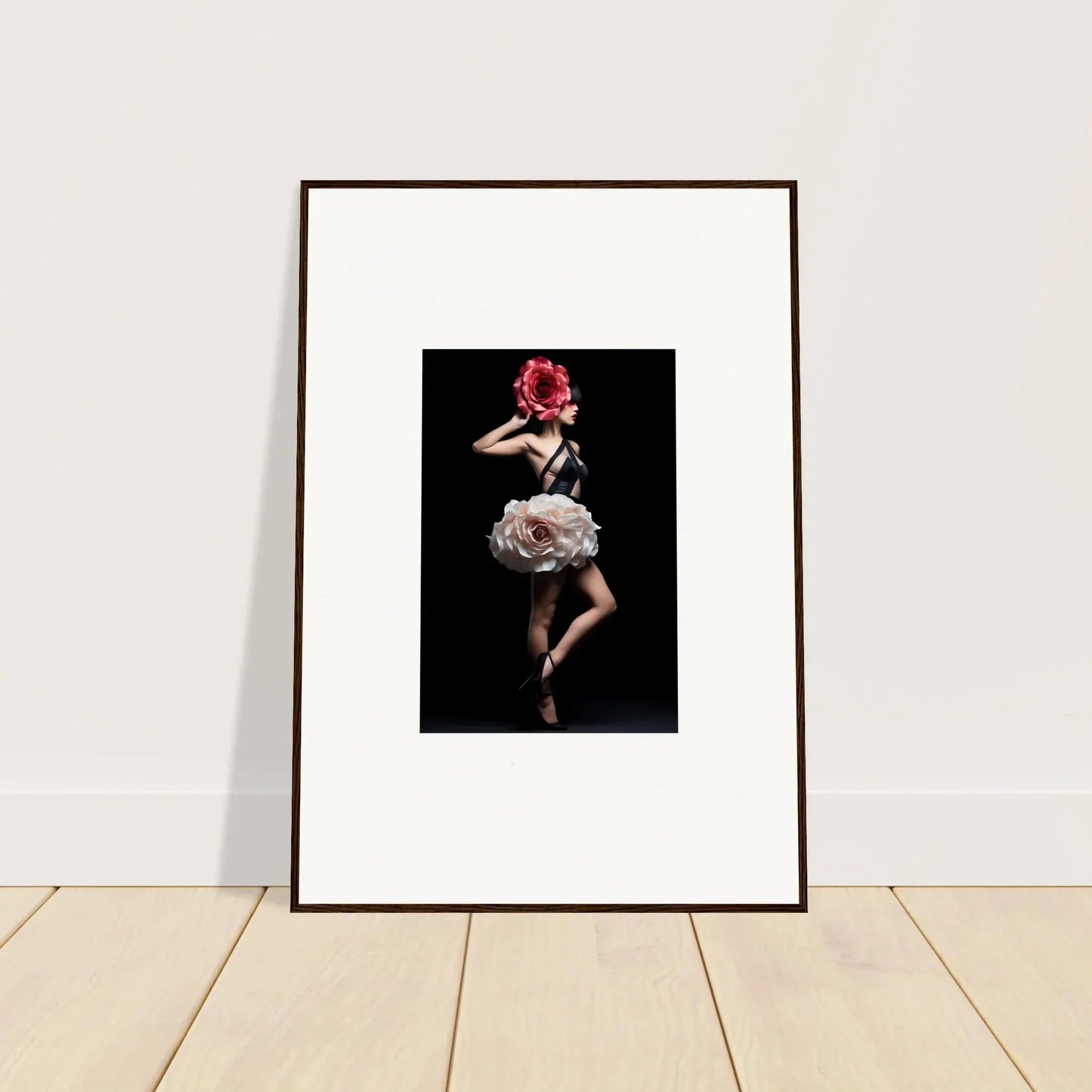 Framed photograph of a woman in a floral dress striking a dramatic pose against a dark background.