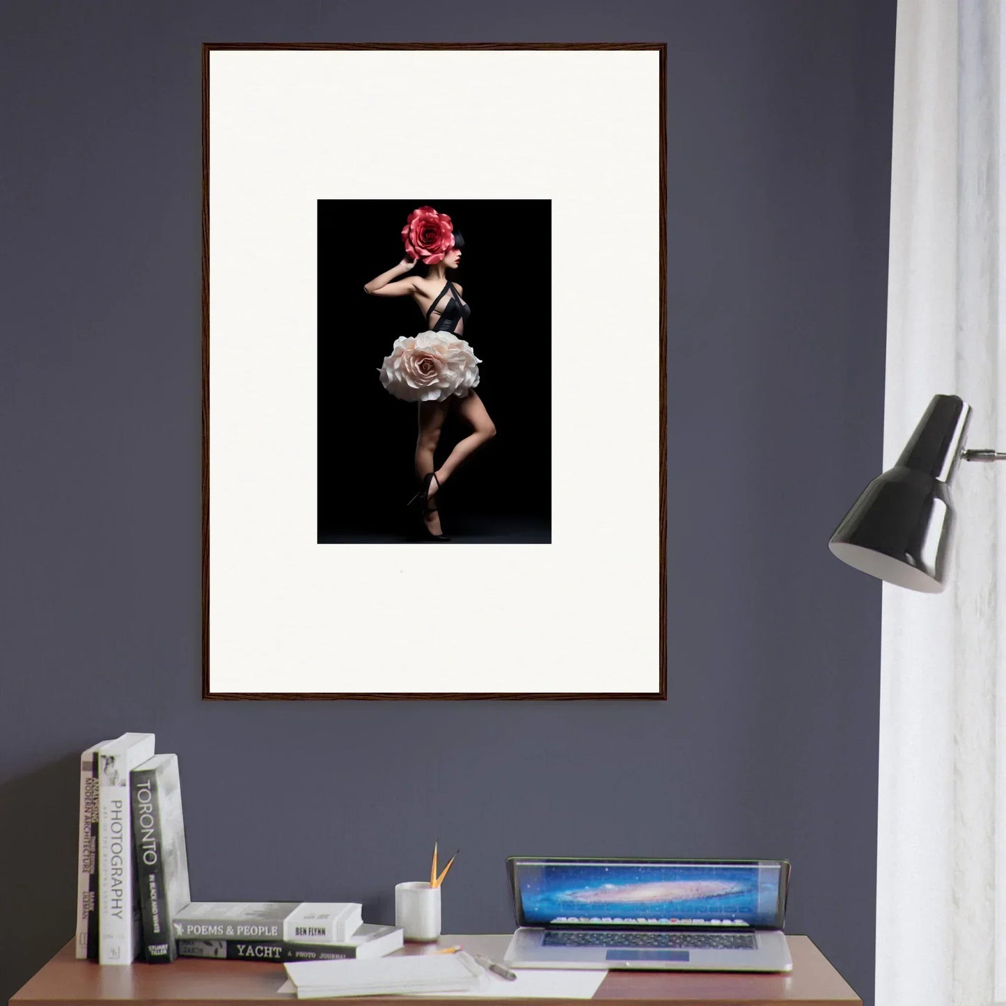 Framed photograph of a dancer in a ruffled dress and red headpiece against a dark background.