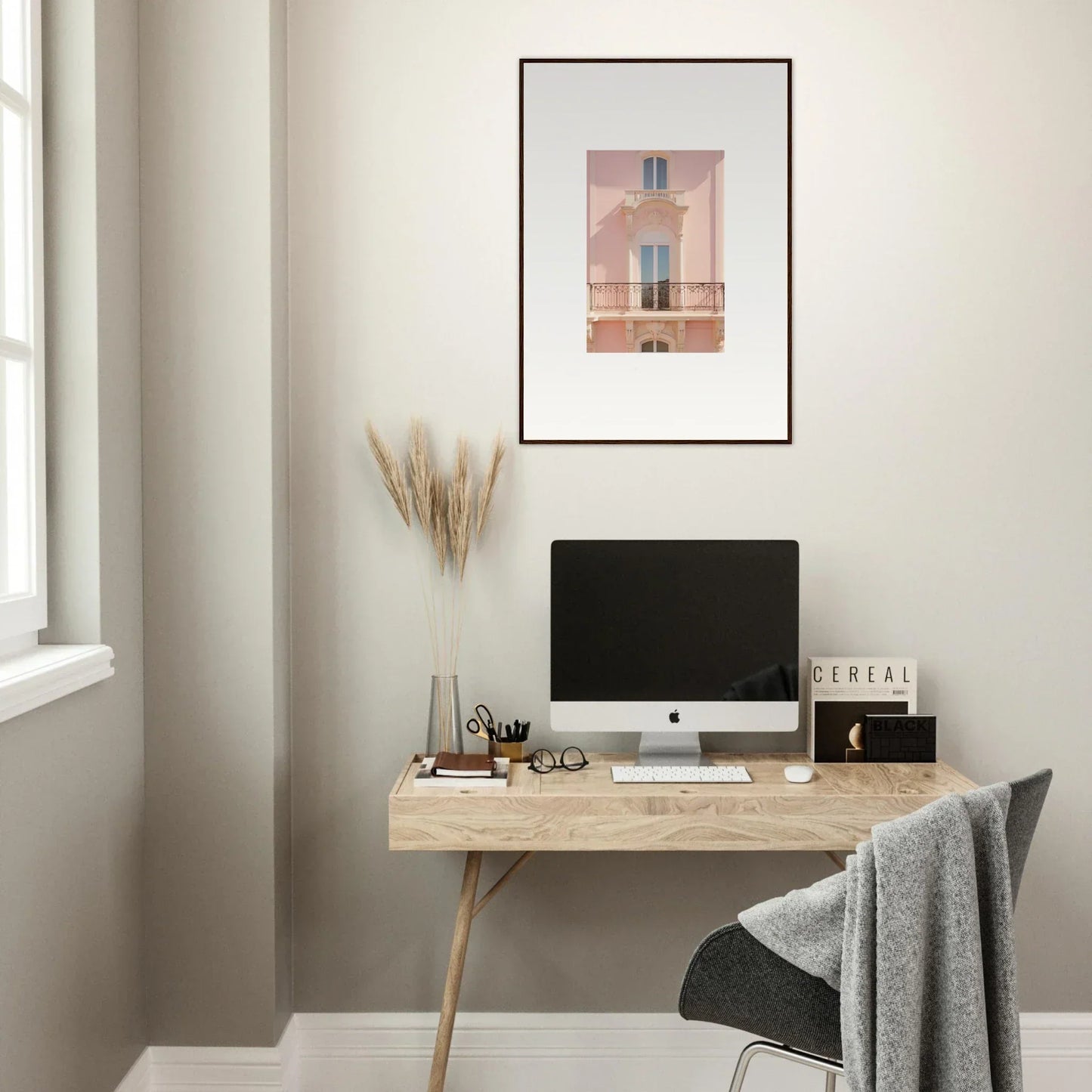 Minimalist wooden desk with iMac and Pink Echoed Dream framed wall art above it