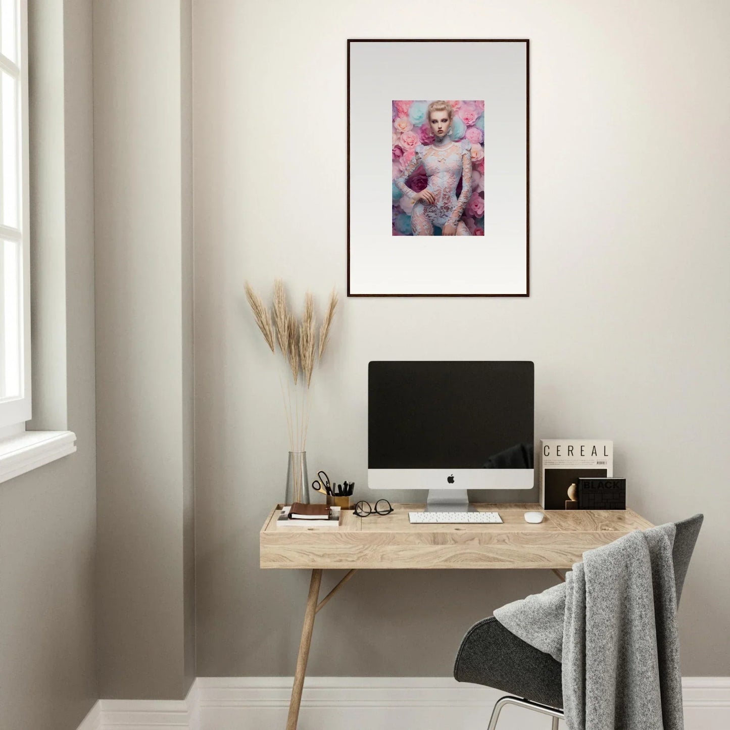 Framed artwork featuring a figure surrounded by pink and purple tones.