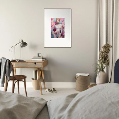 Framed artwork featuring a figure surrounded by pink floral elements.