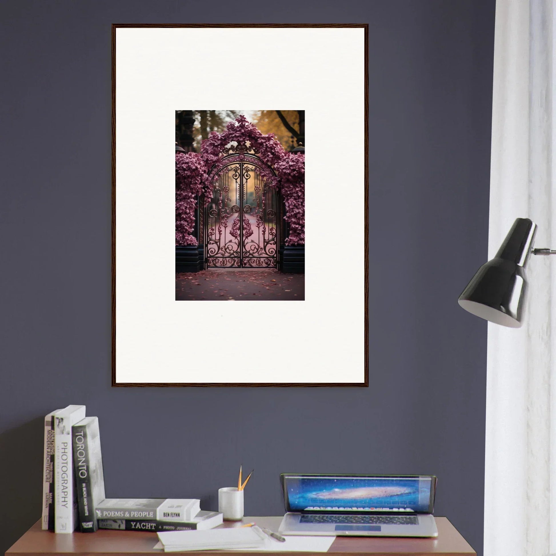 Framed wall art of an ornate iron gate with blooming pink flowers for Prāt Butterfly Turntables