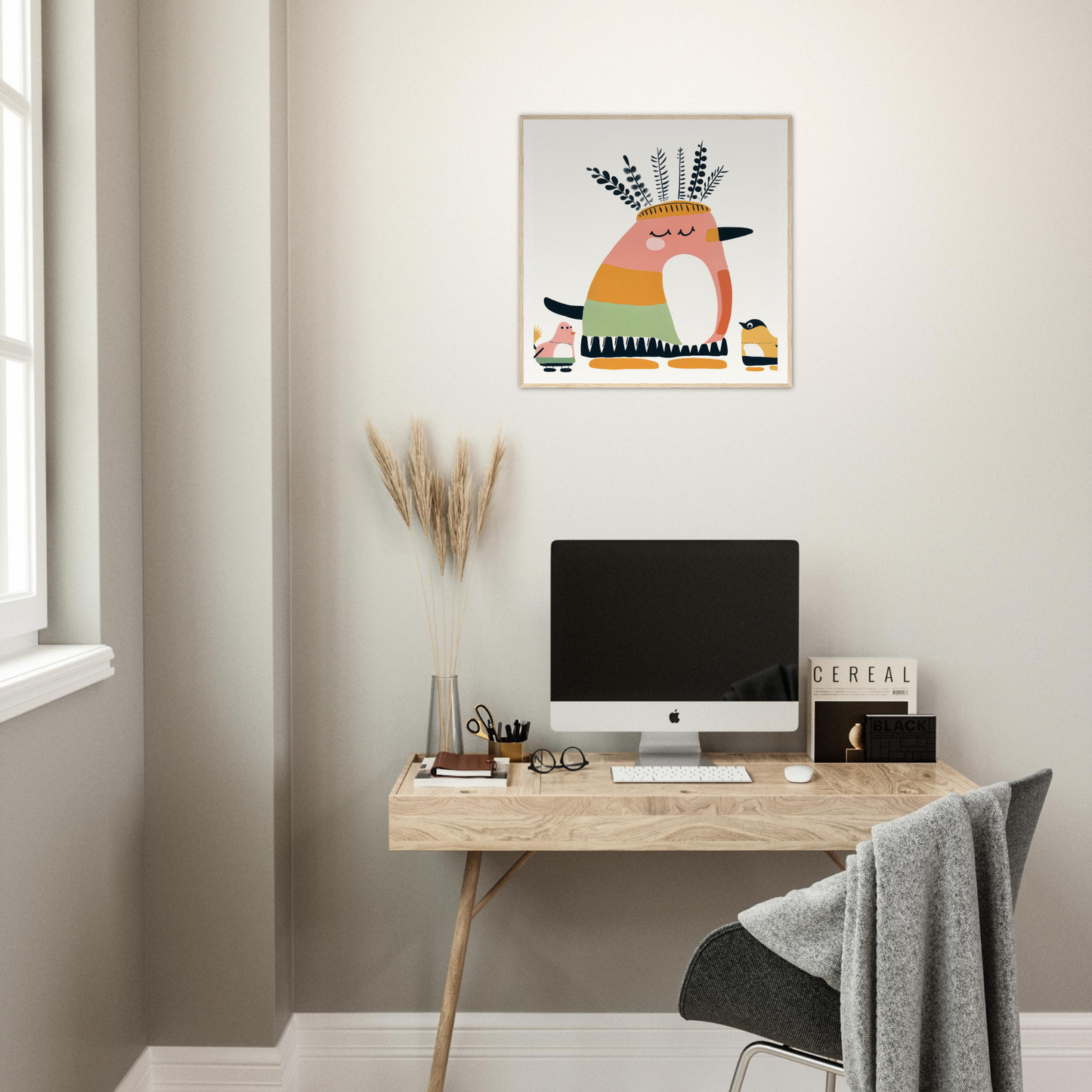 Minimalist workspace featuring an iMac on a wooden desk with stylish nursery decor