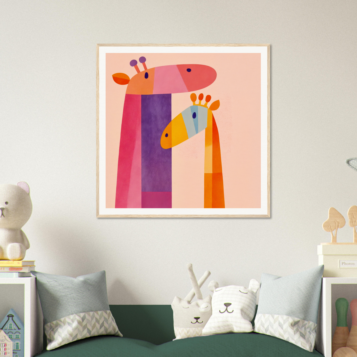 Colorful nursery wall art of two geometric giraffe heads in pink and orange