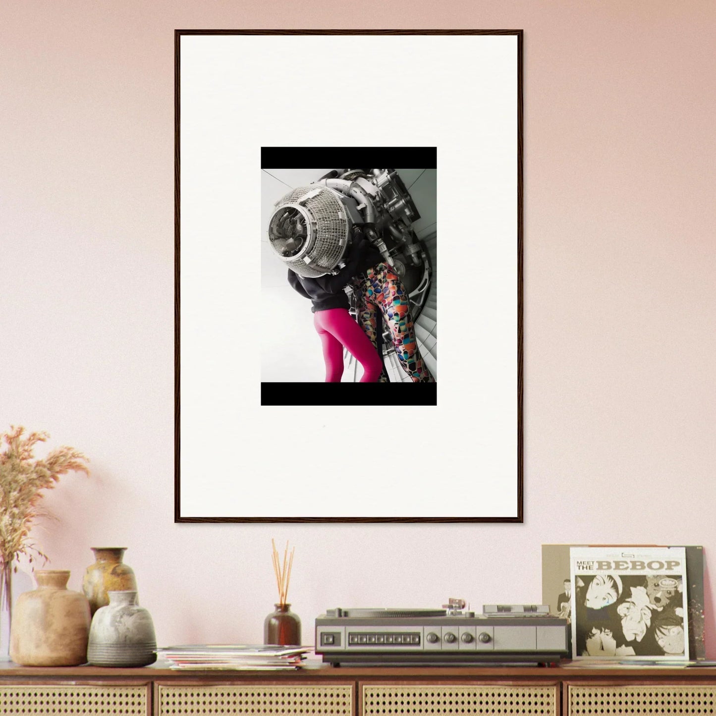 Framed wall art of a person in pink tights and a metallic Magneto Embrace costume