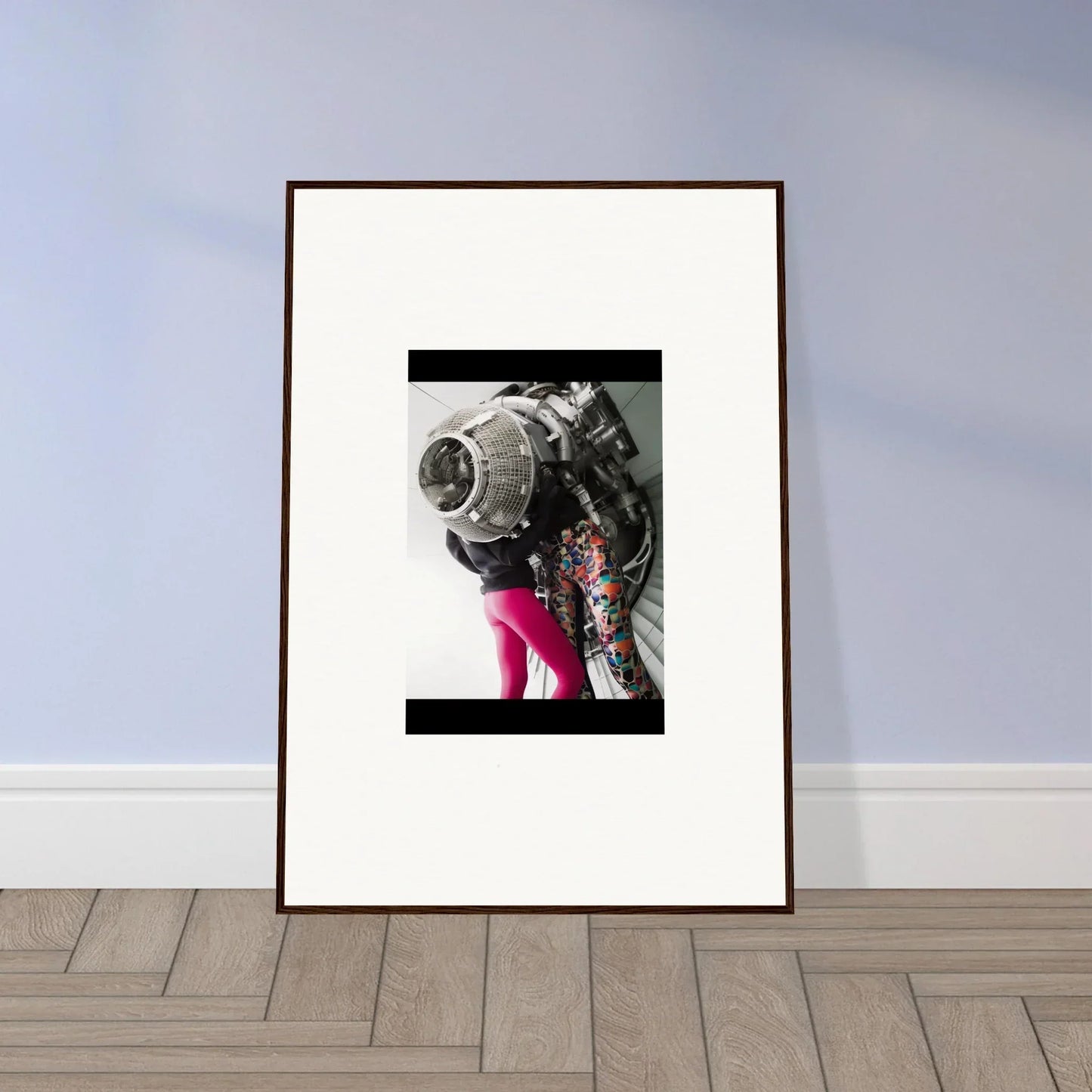 Framed wall art of a black and white astronaut helmet with pink legs, Magneto Embrace decor