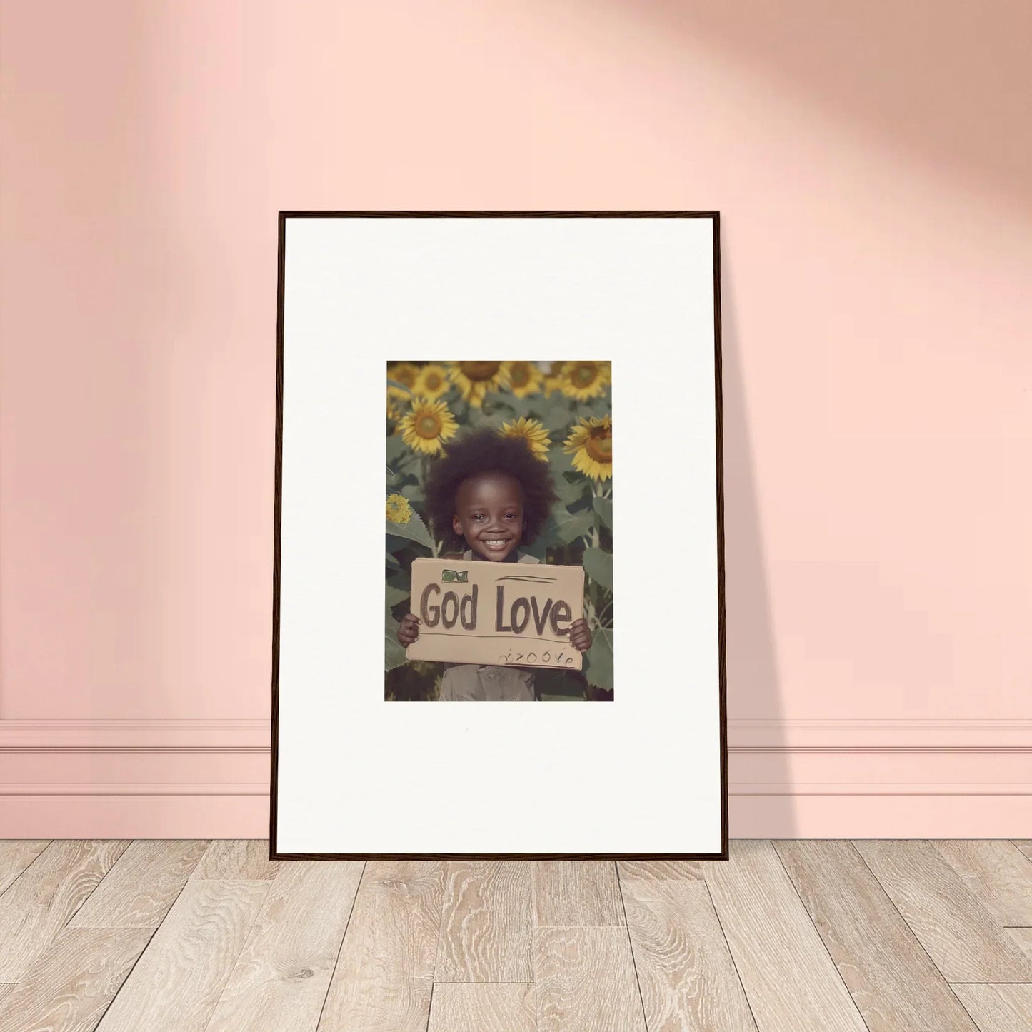 Framed wall art of a child with a God Love sign and sunflowers, daisetism unfolding decor