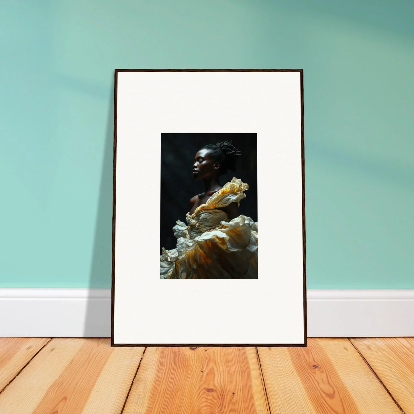 Framed photograph of a person surrounded by flowing fabric or garments.