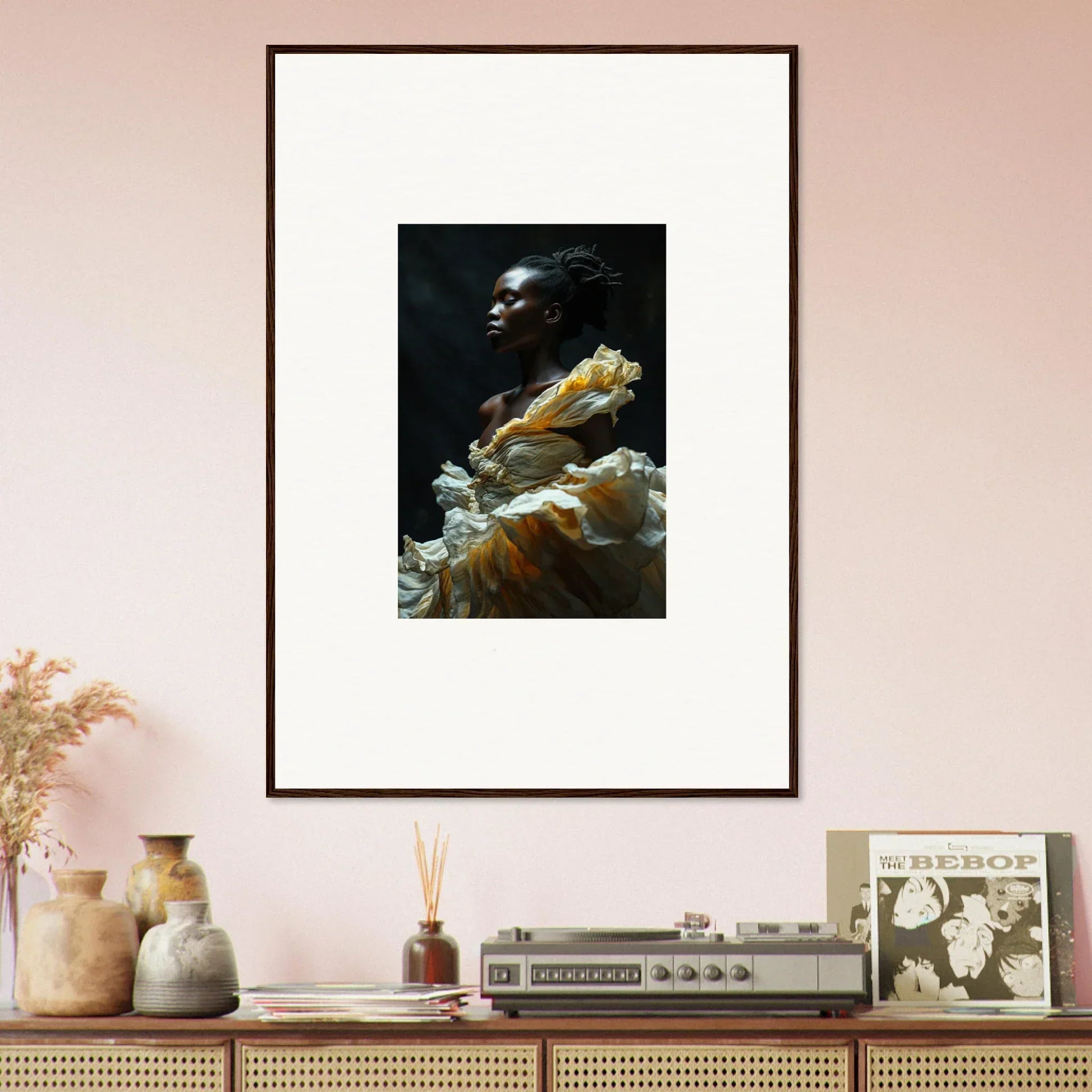 Framed portrait of a person wearing a dramatic yellow and white ruffled garment against a dark background.