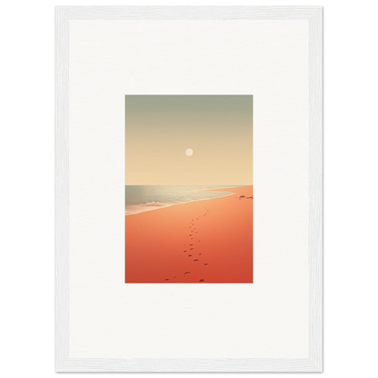 Framed wall art of a sunset beach scene with footprints on red horizons sand