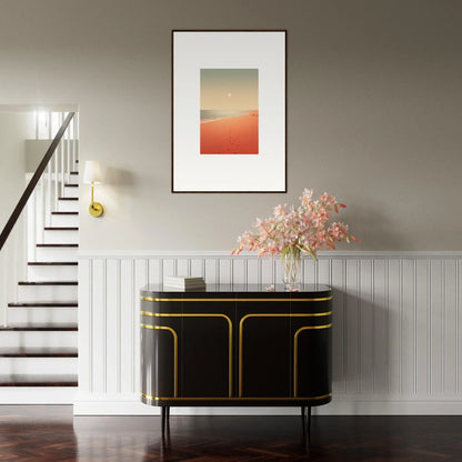 Elegant black and gold console table enhancing room decor with framed wall art