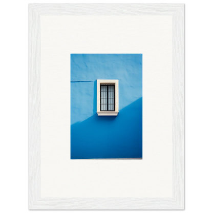 White-framed window with black bars on a bright blue wall in Reflective Cerulean Daydreams