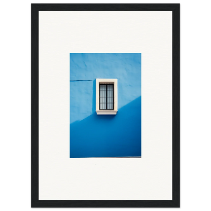 White-framed window with black bars on a bright blue wall in Reflective Cerulean Daydreams