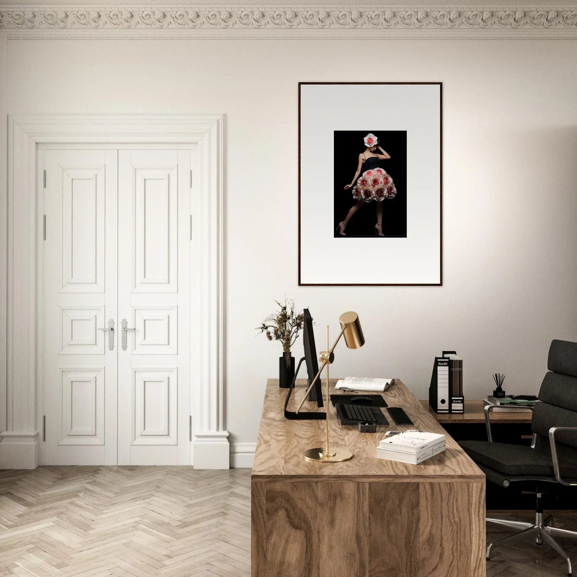 Elegant home office with a wooden desk, framed artwork, and classic white double doors.