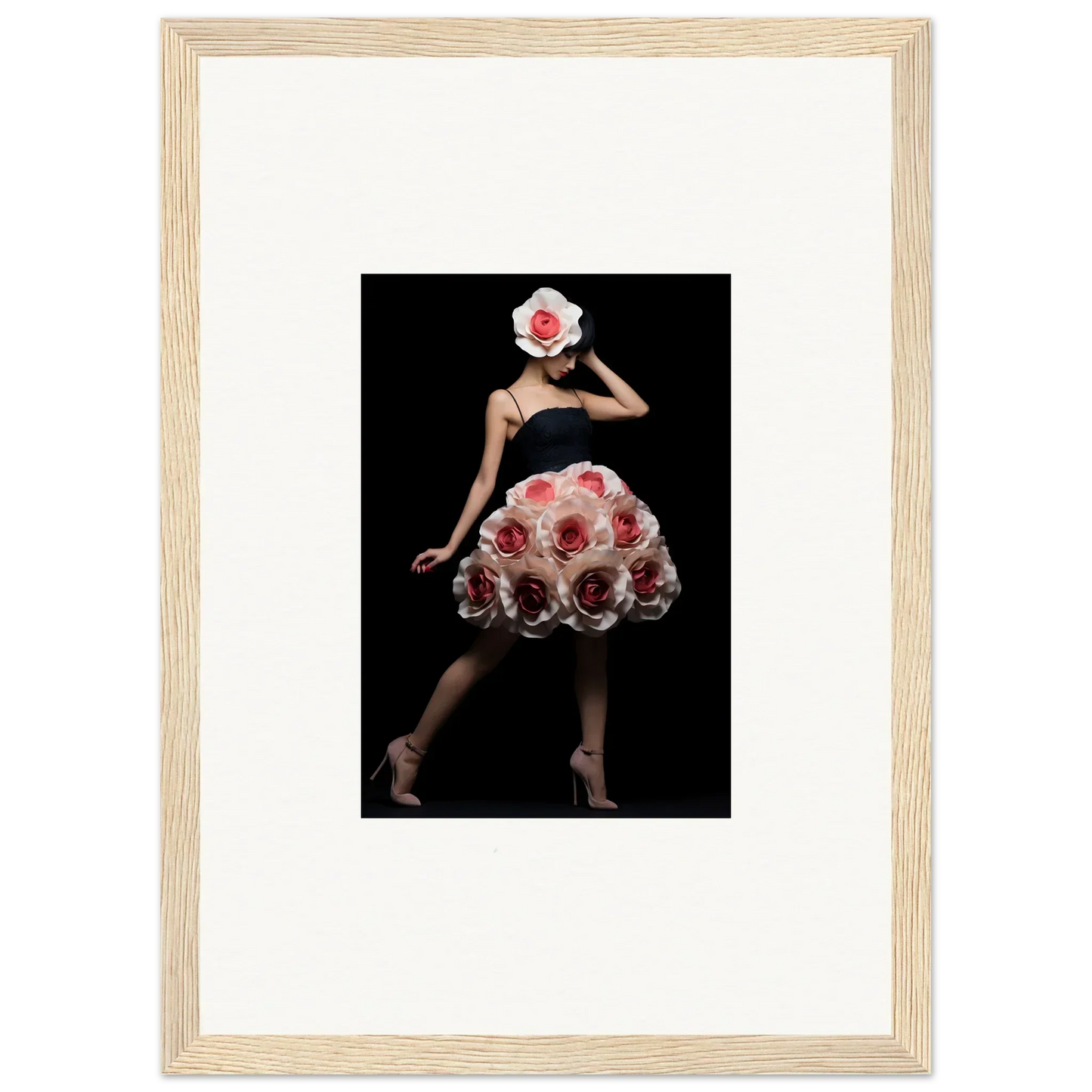 Framed photograph of a figure wearing a dress and headpiece made of red roses against a black background.