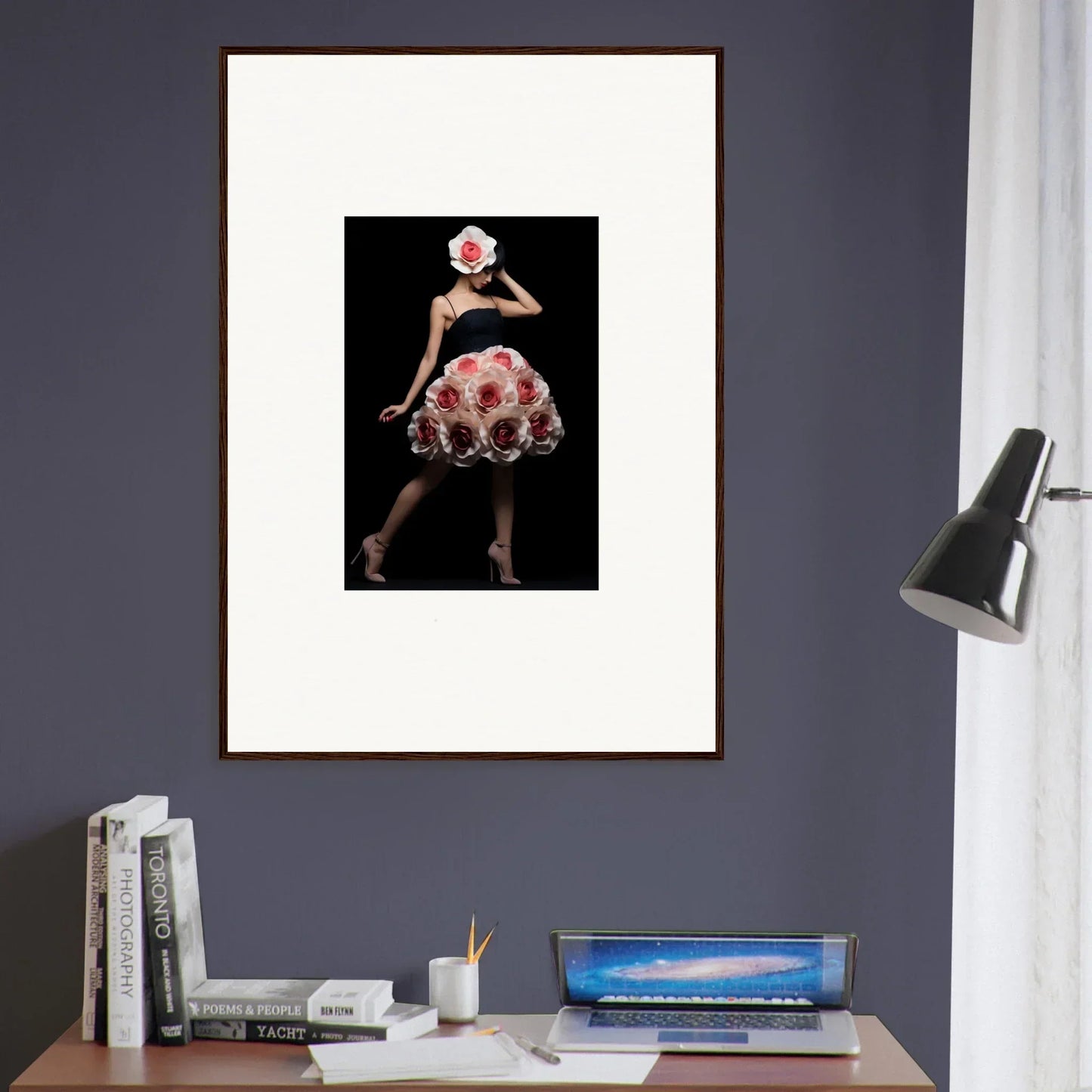 Framed photograph of a person wearing a floral dress and matching hat against a dark background.