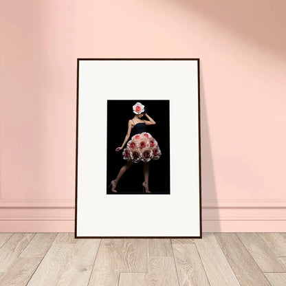 Framed photograph of a person wearing a floral dress and white hat against a dark background.