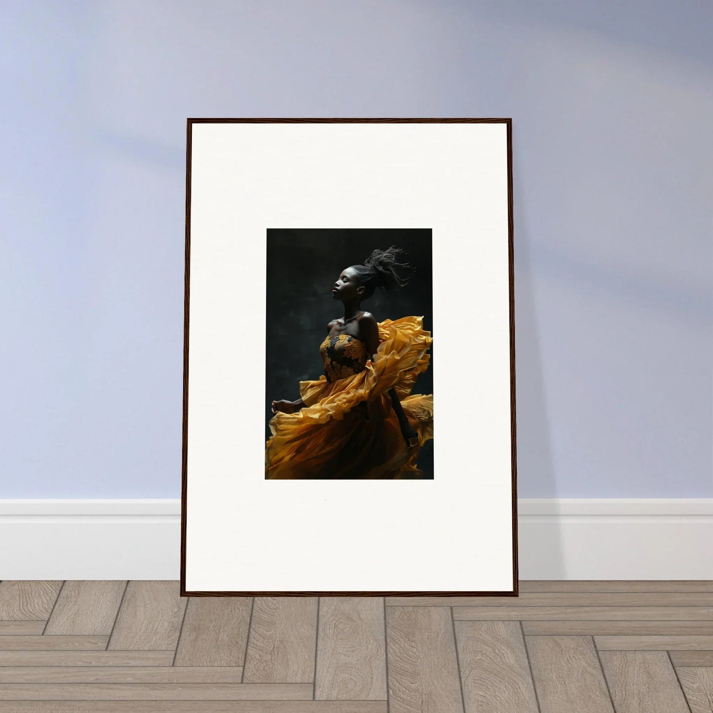 Framed artwork depicting a person in a golden yellow garment against a dark background.