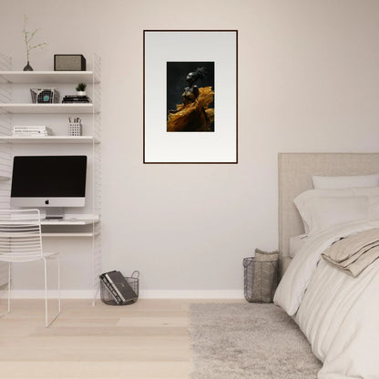 Framed photograph of a dark bird perched on a golden-hued rock or branch.