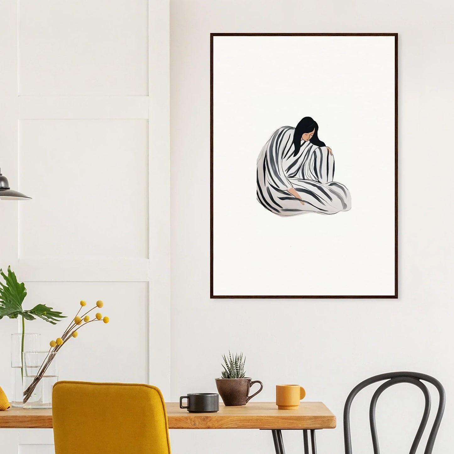 Framed canvas print of a figure wrapped in a striped blanket for stylish room decoration