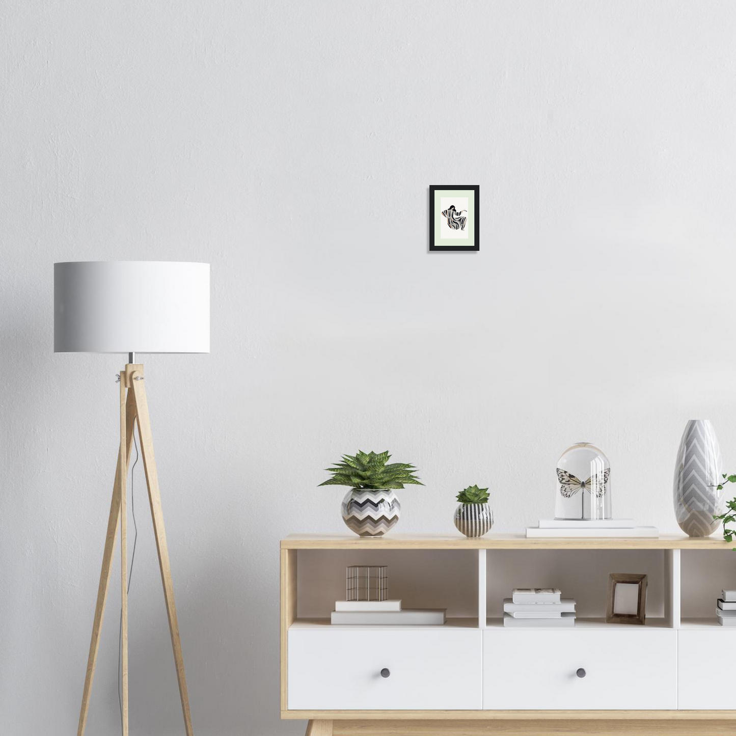 Wooden sideboard with white drawers and open shelving displaying various decorative objects.