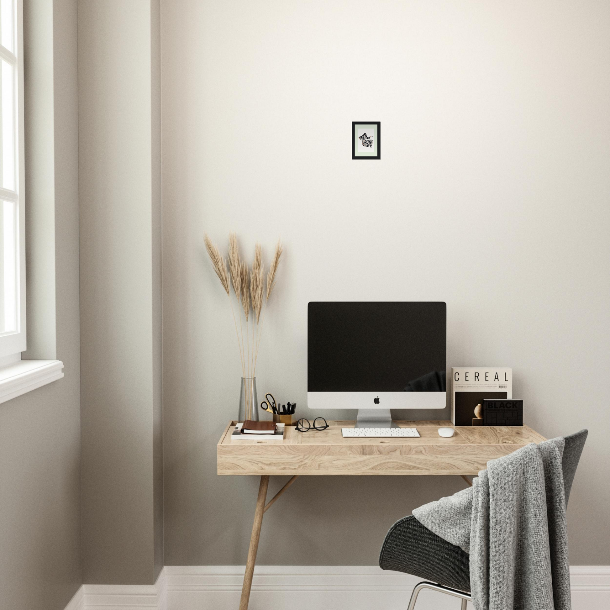 Wooden desk with a computer monitor and various office accessories.