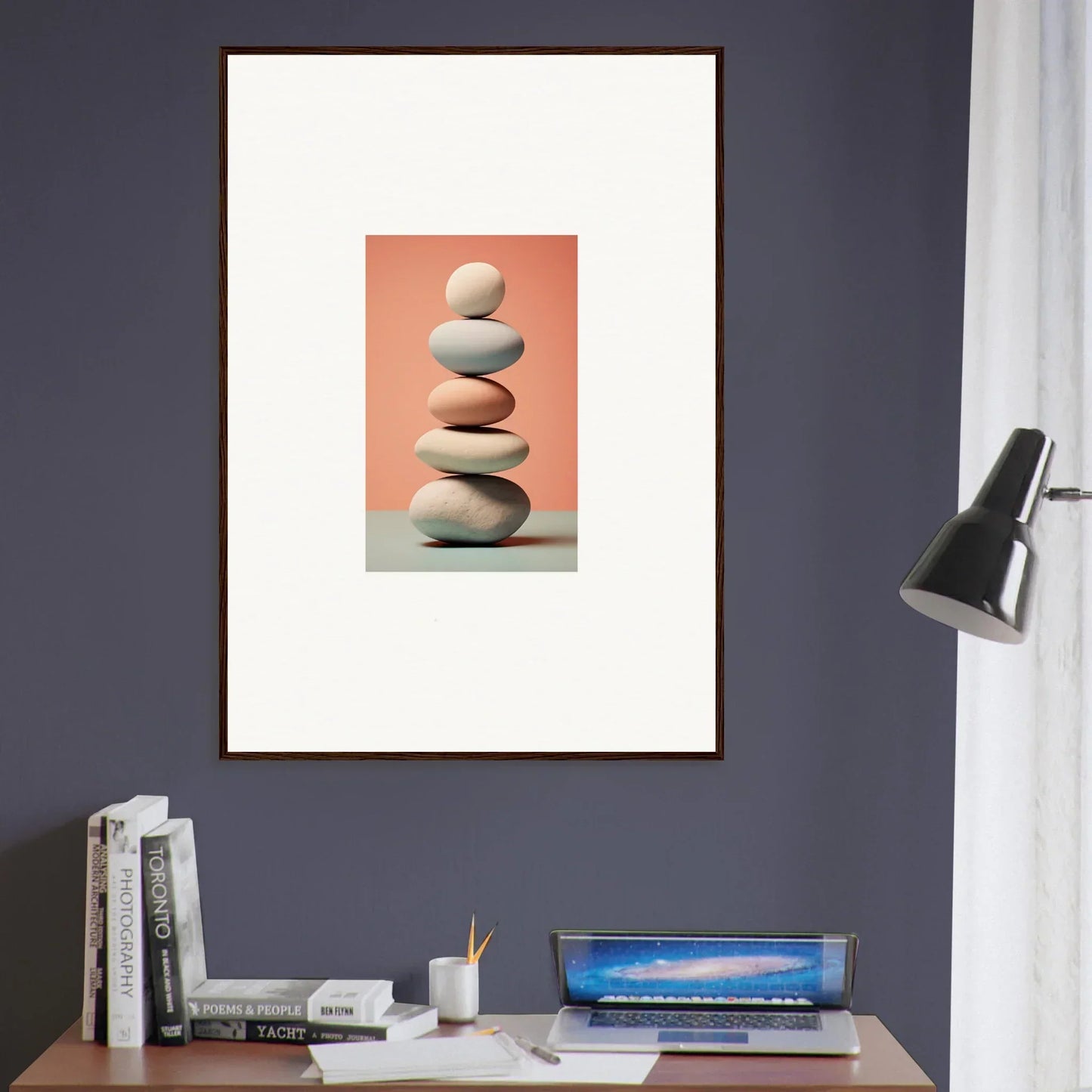 Framed canvas print of balanced stones on peach background for room decoration with marble sands