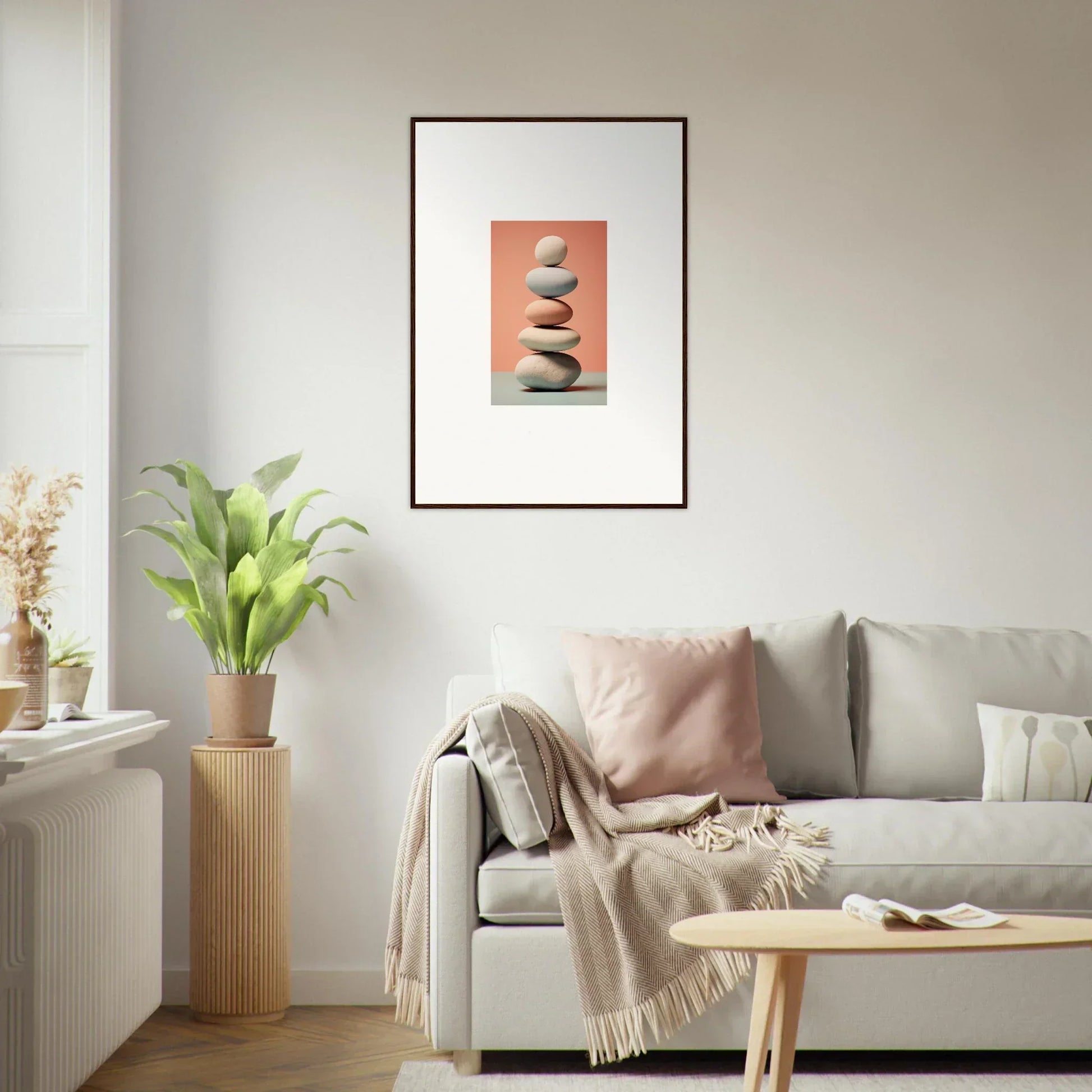 Framed canvas print of stacked stones on coral background for chic room decoration