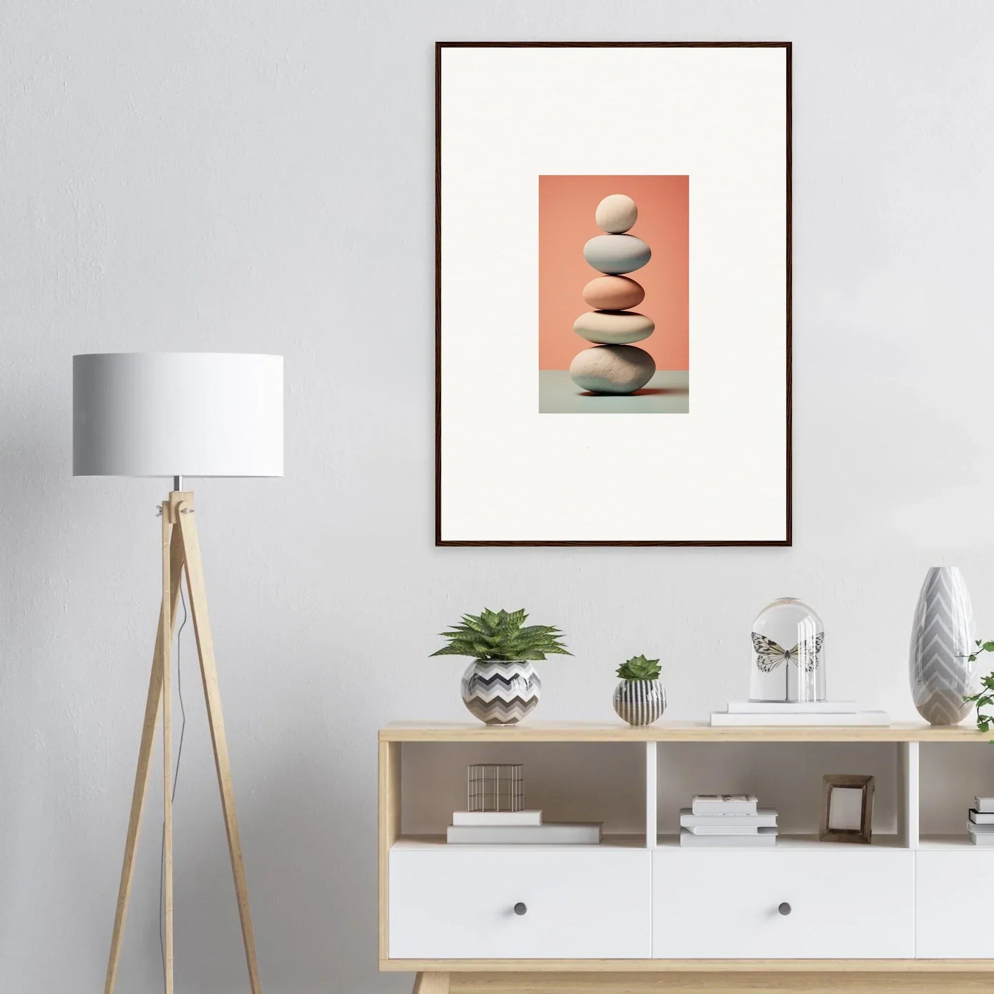 Framed canvas print of stacked stones on peach, perfect for room decoration with marble sands