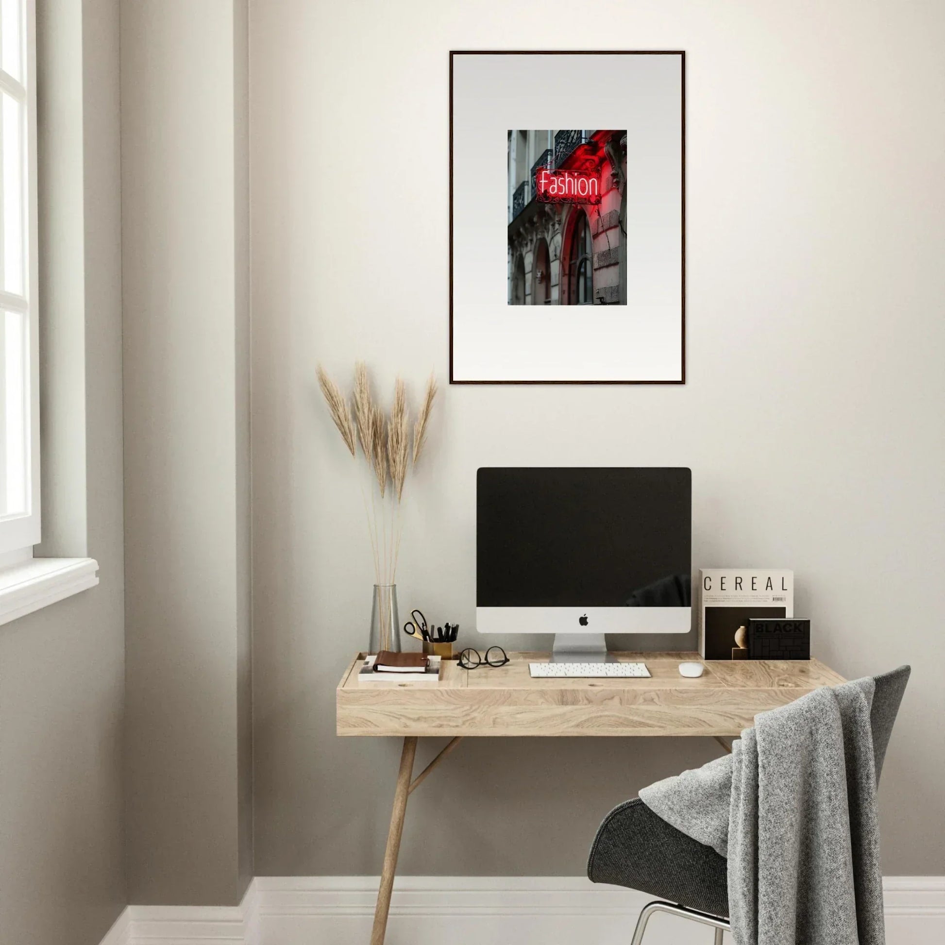 Minimalist home office with wooden desk, computer, and Skylight Manifesto wall art