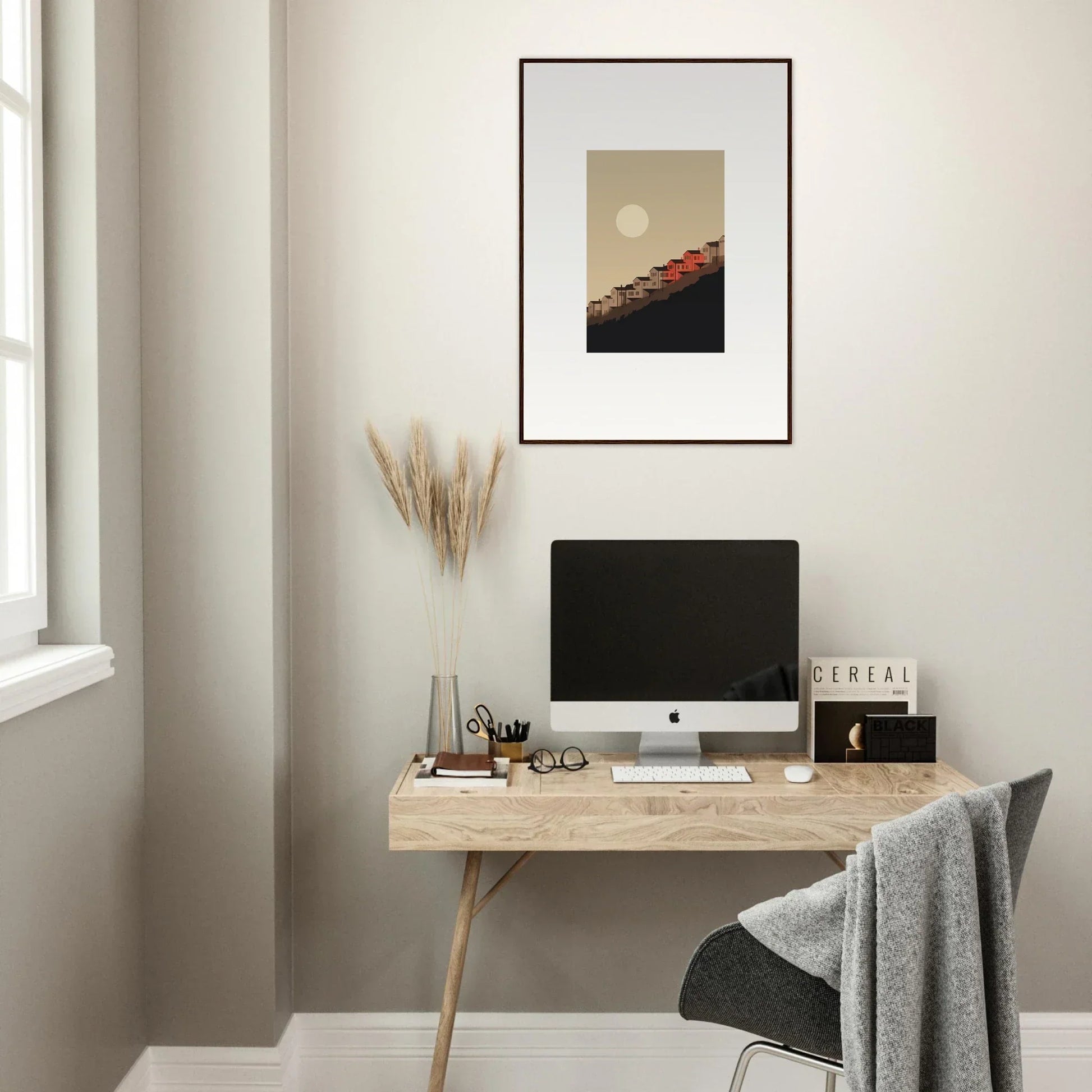 Minimalist home office with wooden desk, computer, and framed wall art for room decor