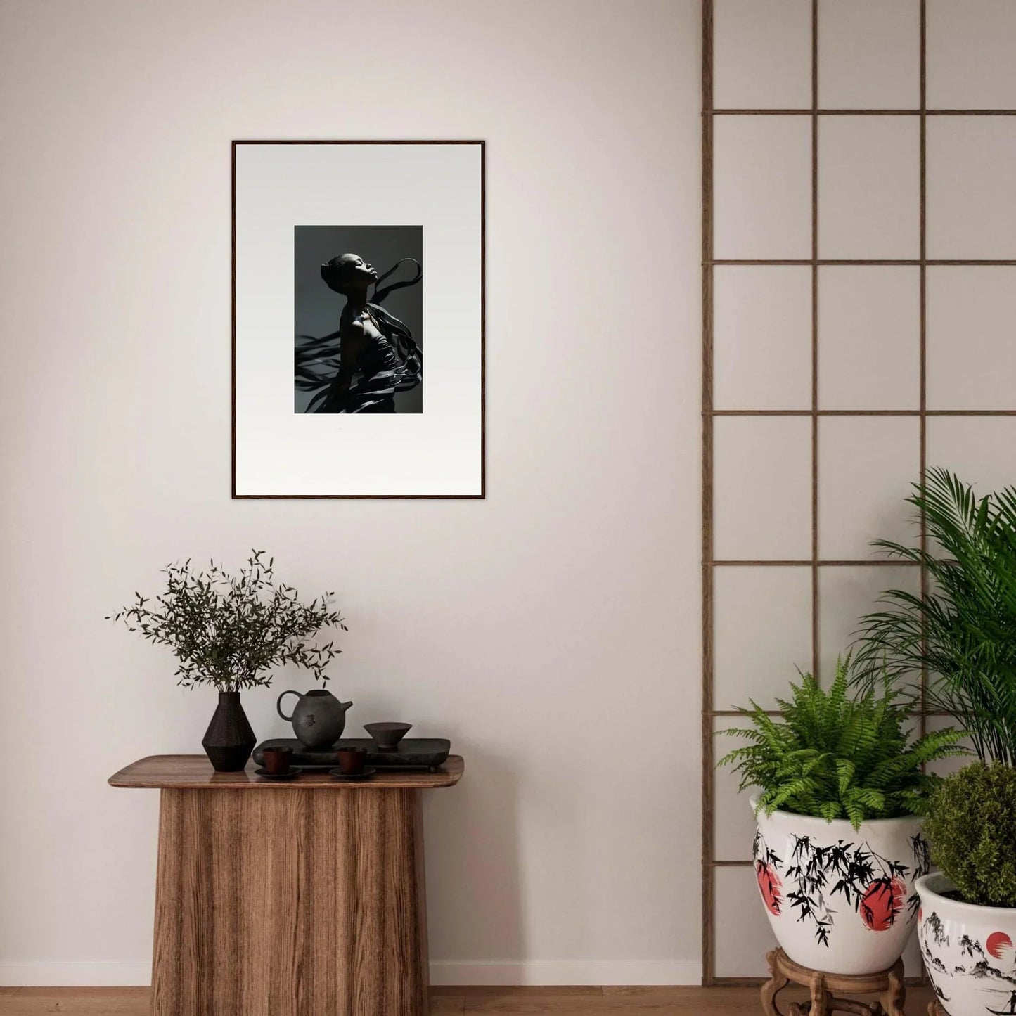 Framed black and white photograph of a person wearing a hat, mounted on a light-colored wall.