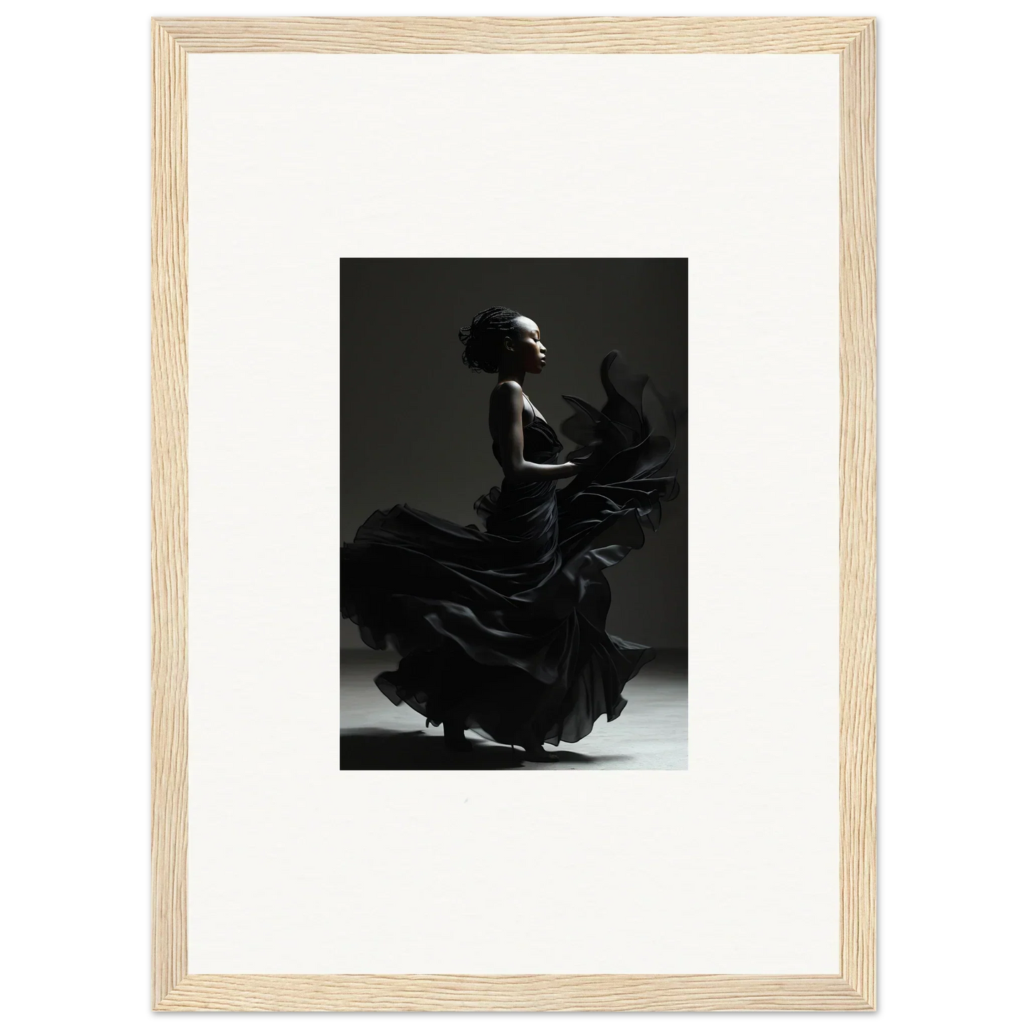 Black and white photograph of a flamenco dancer in motion, framed in light wood.