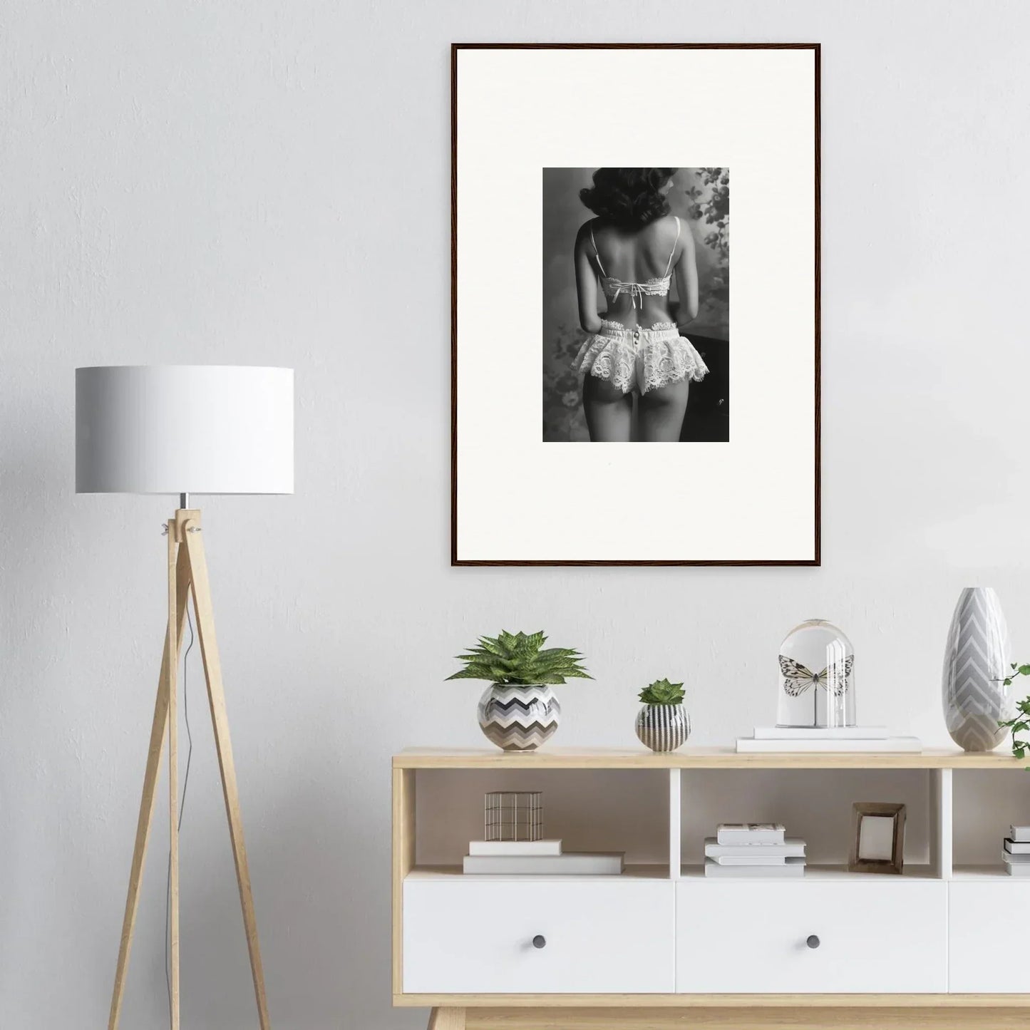 Framed black and white photograph of a person in ruffled garment for room decor