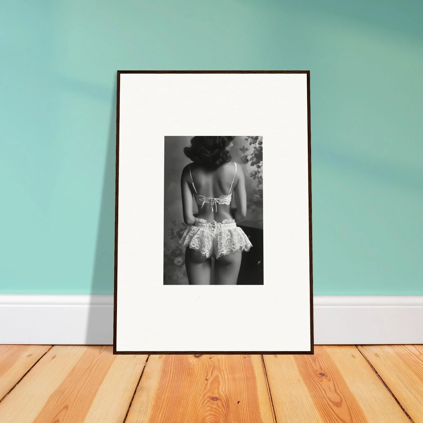 Framed black and white wall art of a person in a lacy garment for elegant room decor