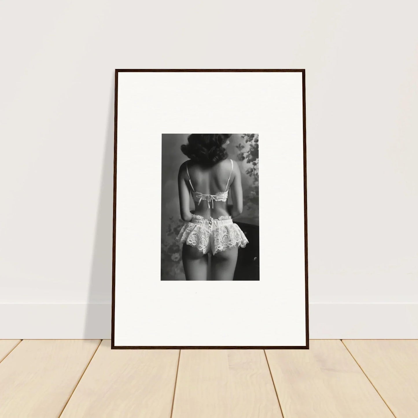 Framed black and white wall art of a person in a lacy garment for elegant room decor