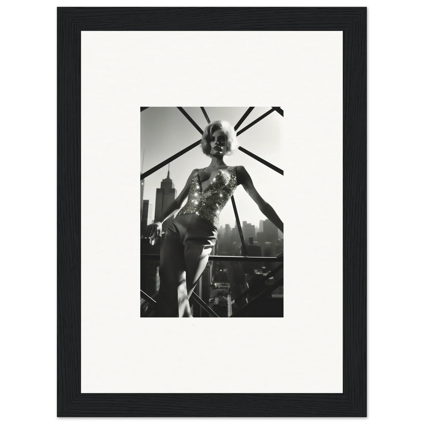 Black and white photograph of a performer on stage, framed and matted.