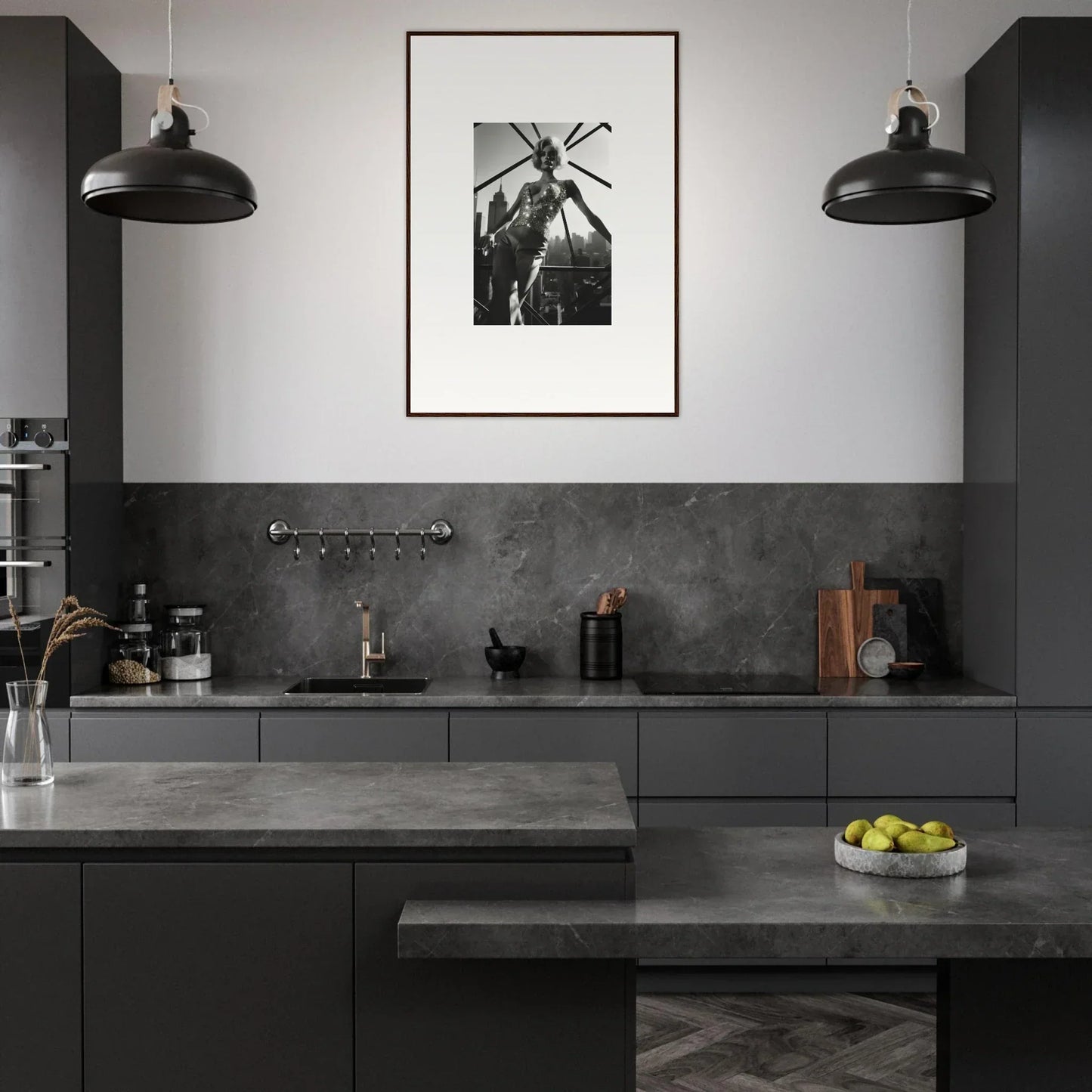 Modern kitchen with dark gray cabinetry and countertops, featuring a black and white framed photograph on the wall.