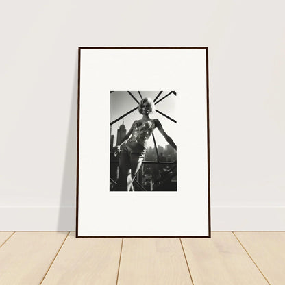 Framed black and white photograph of a sculpture depicting a tall, slender figure with elongated limbs.