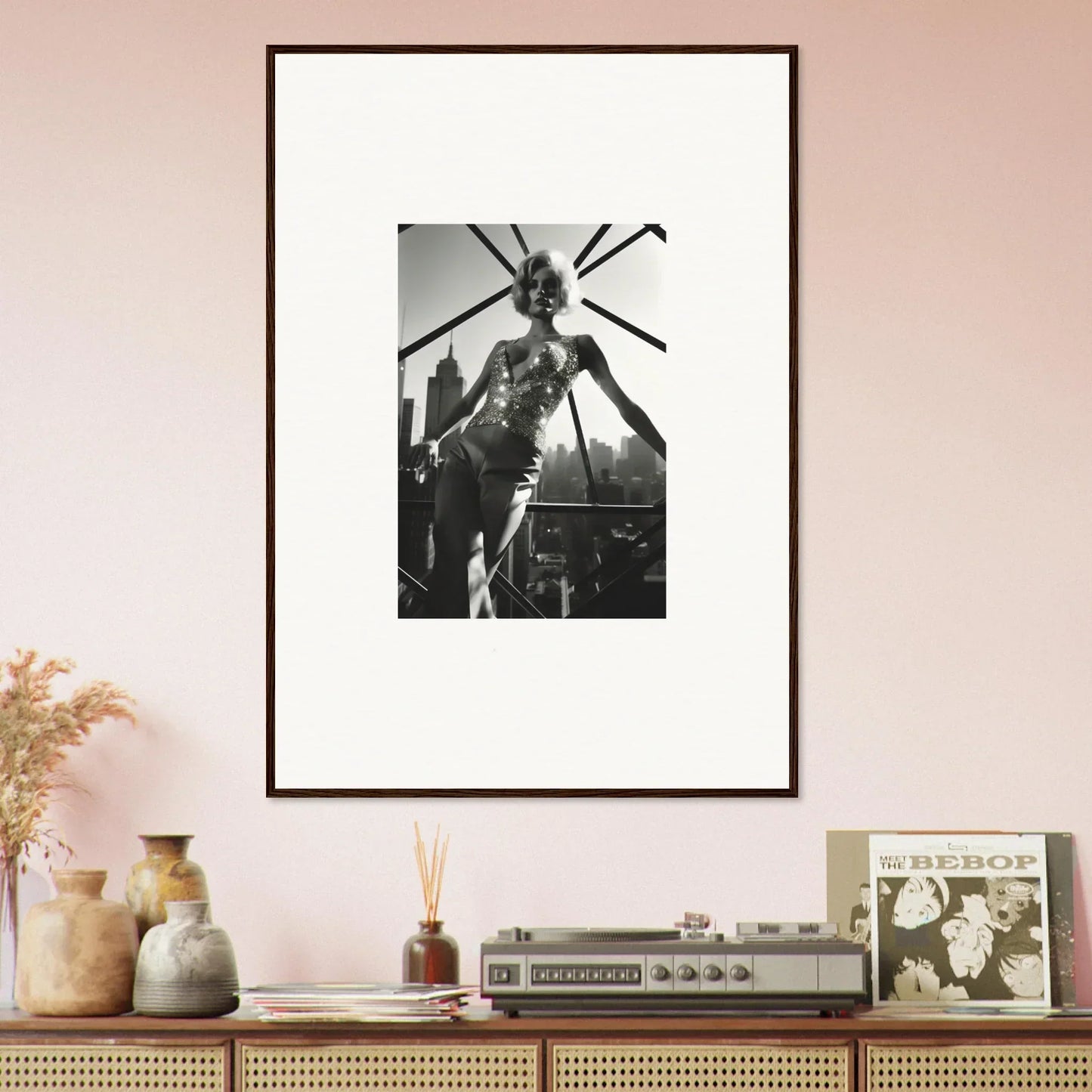 Framed black and white photograph of a person on stage with microphone stands.