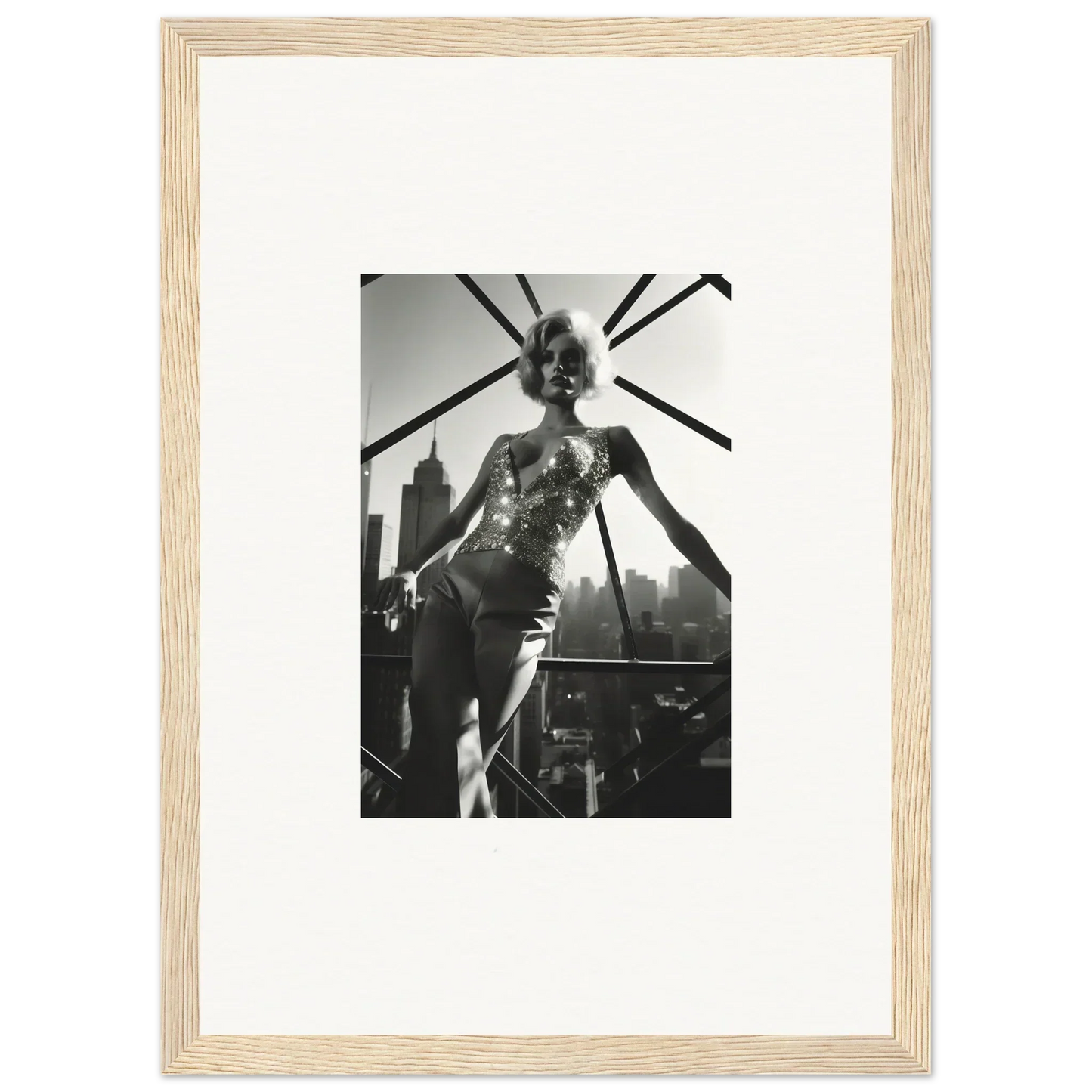 Black and white photograph of a performer on stage, framed in a light wooden frame.