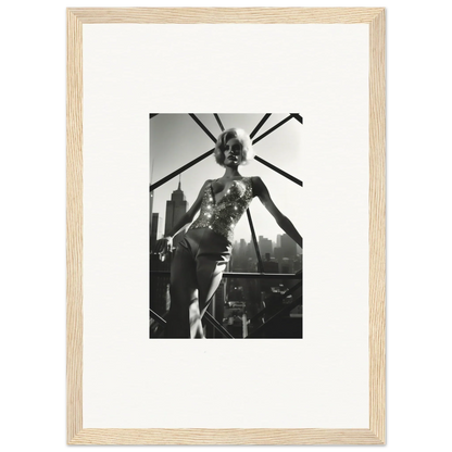 Black and white photograph of a performer on stage, framed in a light wooden frame.