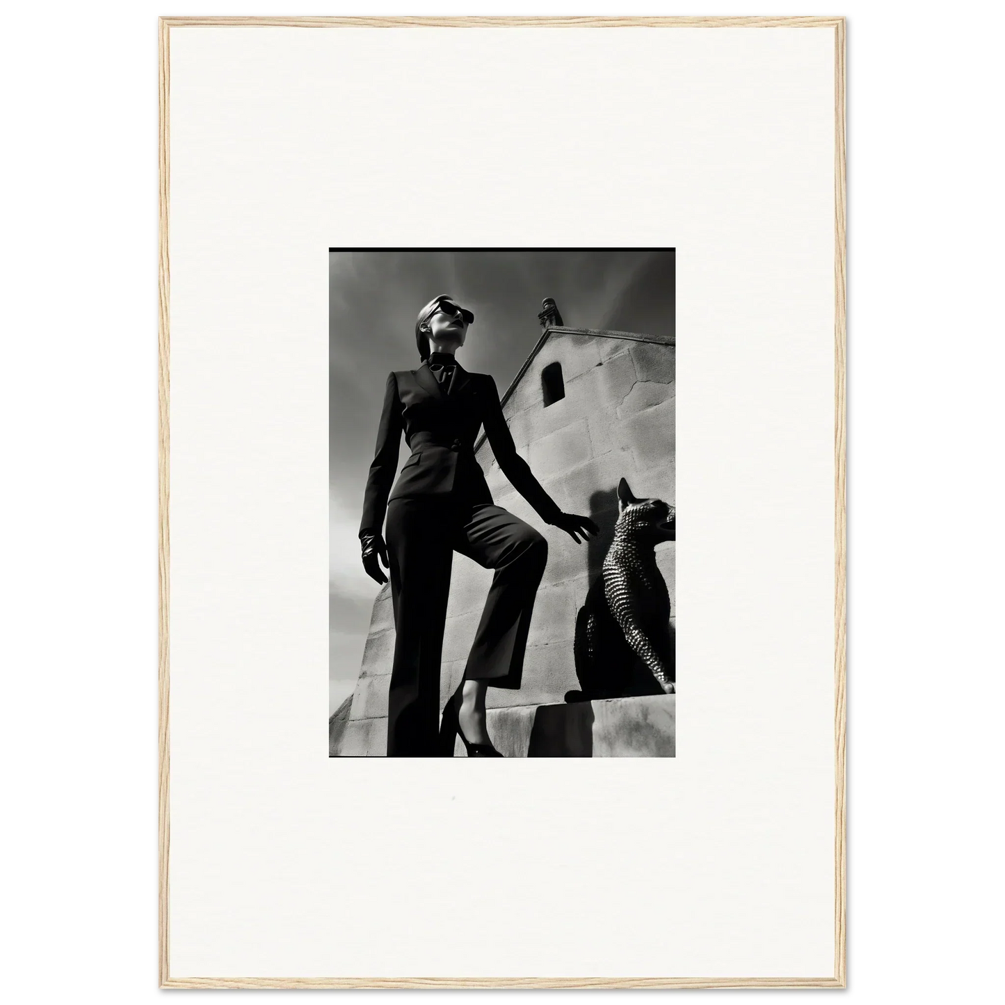 Black and white photograph of a person posing next to a sculptural form.