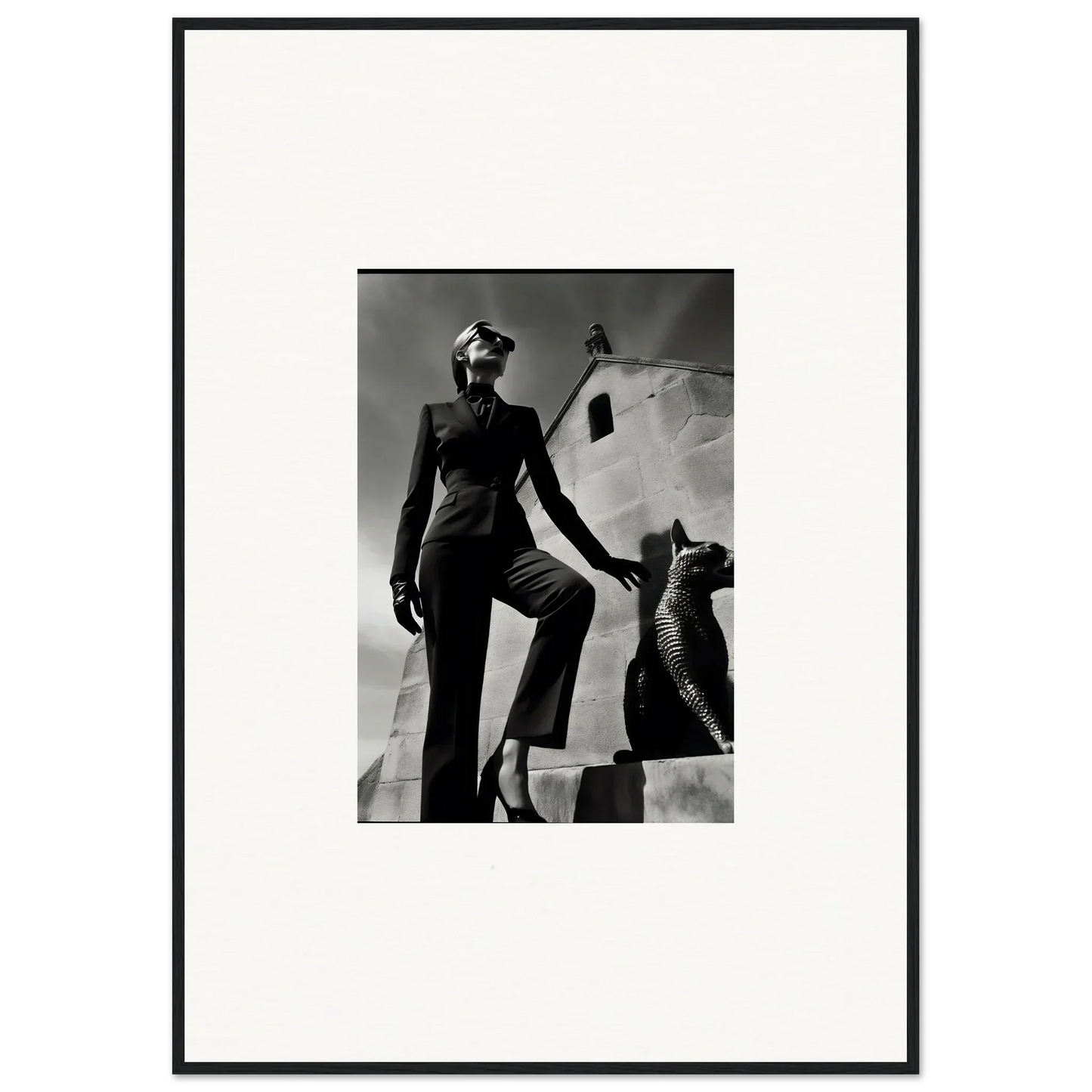 Black and white photograph of a stylishly dressed woman posing next to a sculptural form.