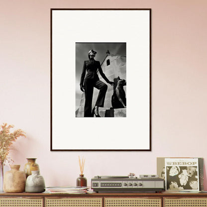 Framed black and white photograph of a stylishly dressed figure in a dramatic pose.