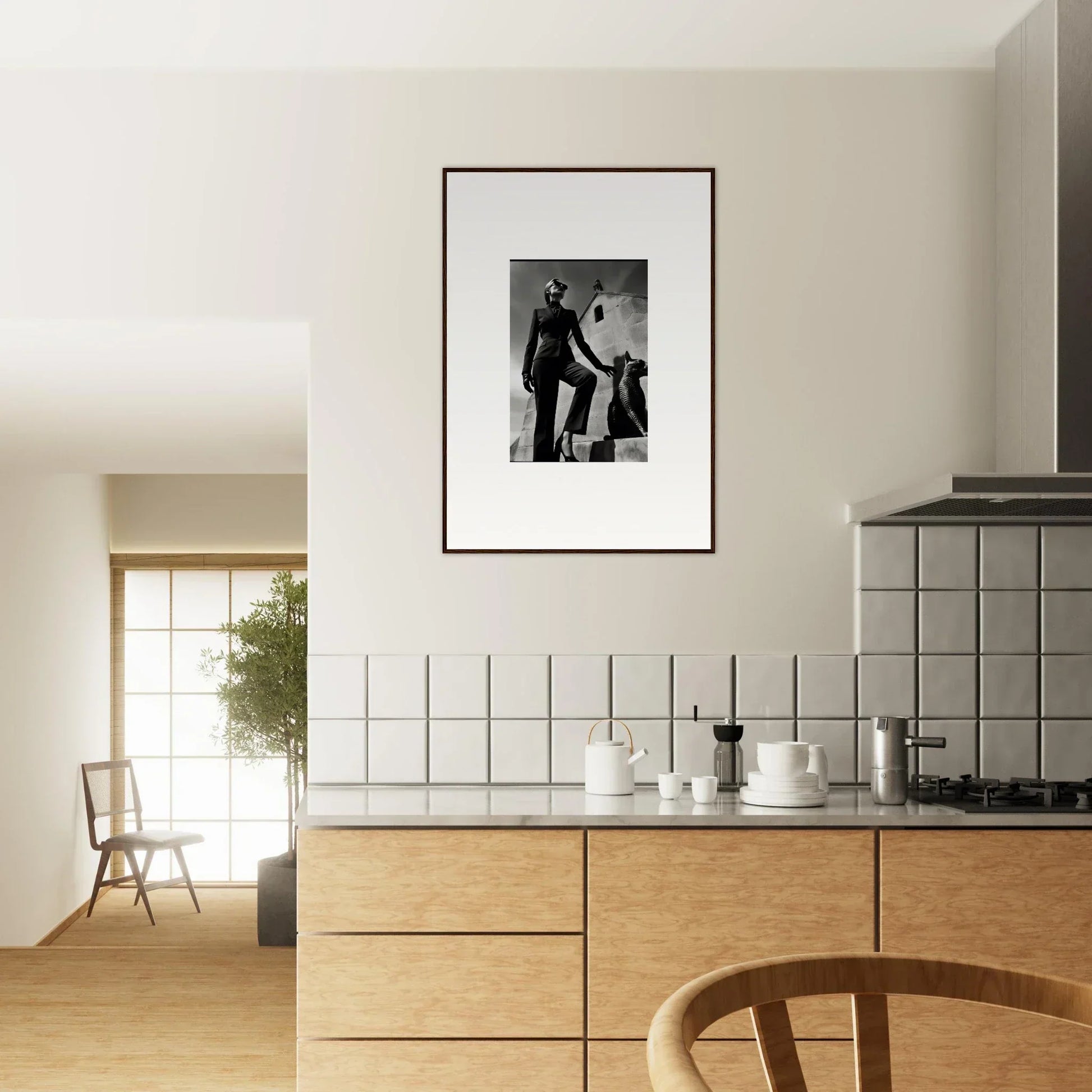 Framed black and white photograph hanging on a wall above a kitchen counter.