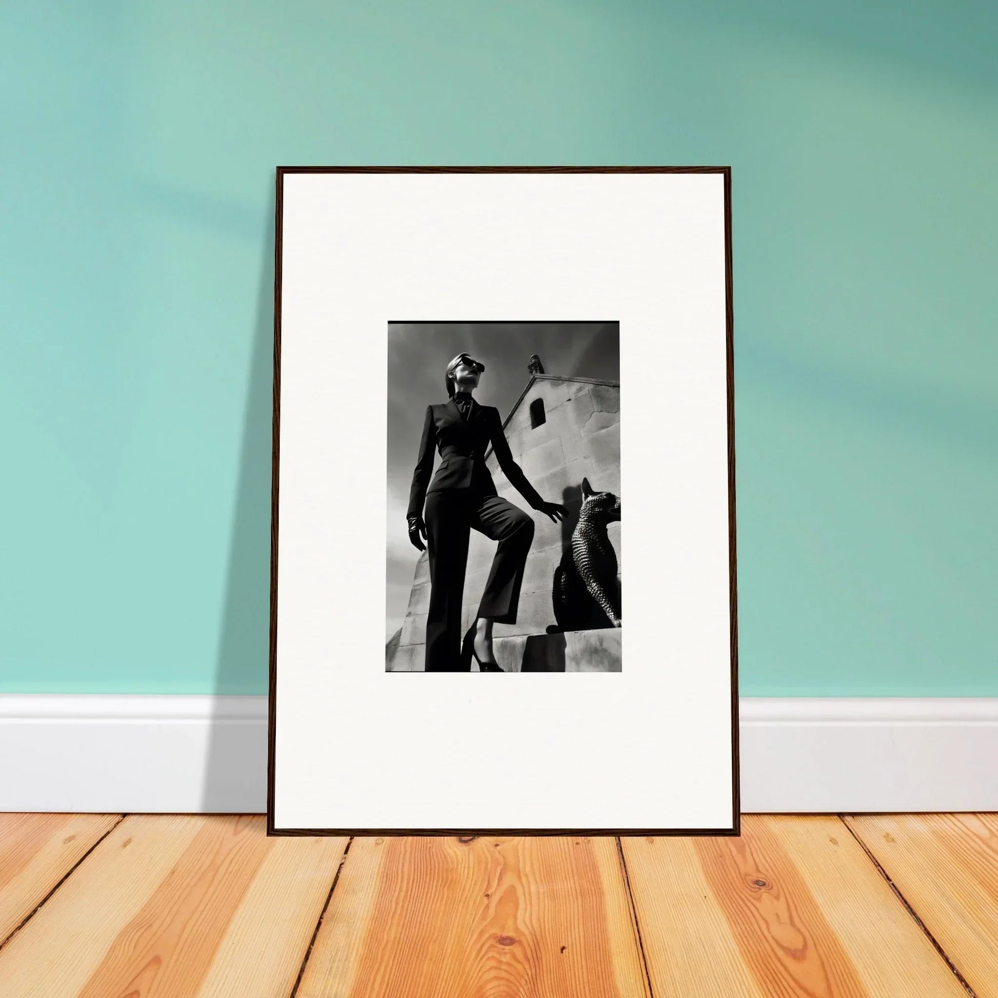 Framed black and white photograph leaning against a wall.