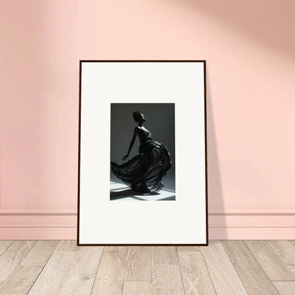 Framed black and white photograph of a graceful figure in a flowing dress.